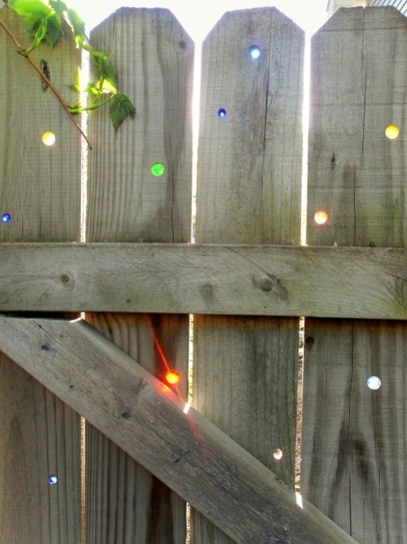 DIY garden Art. Glass Marbles In The Fence Trusper